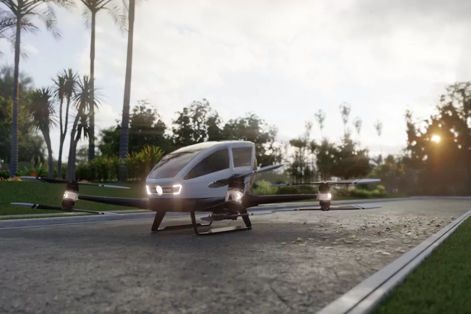 Rendering of small autonomous 'air taxi' parked on gray stone driveway.